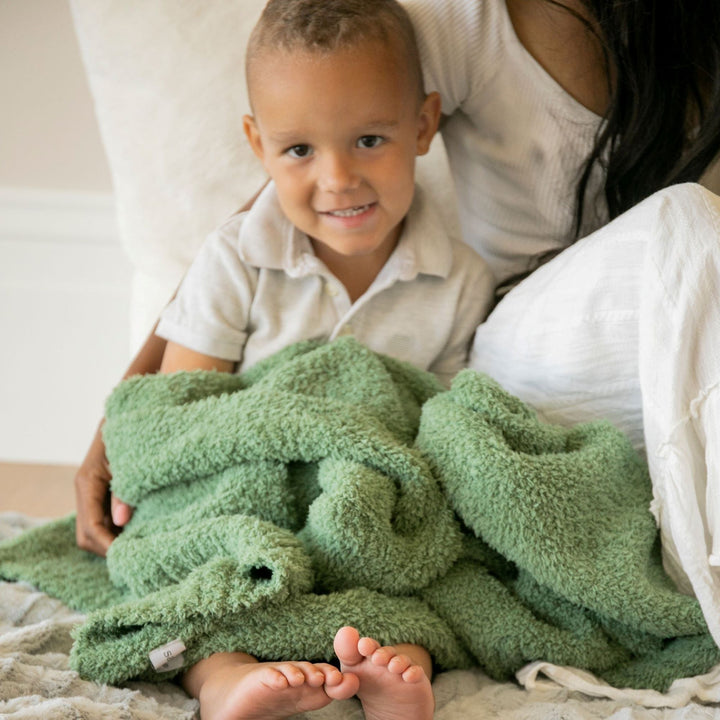 Snuggle time feels magical with the Saranoni Bamboni¨ Receiving Blanket in Olive, a soft baby blanket youÕll adore.