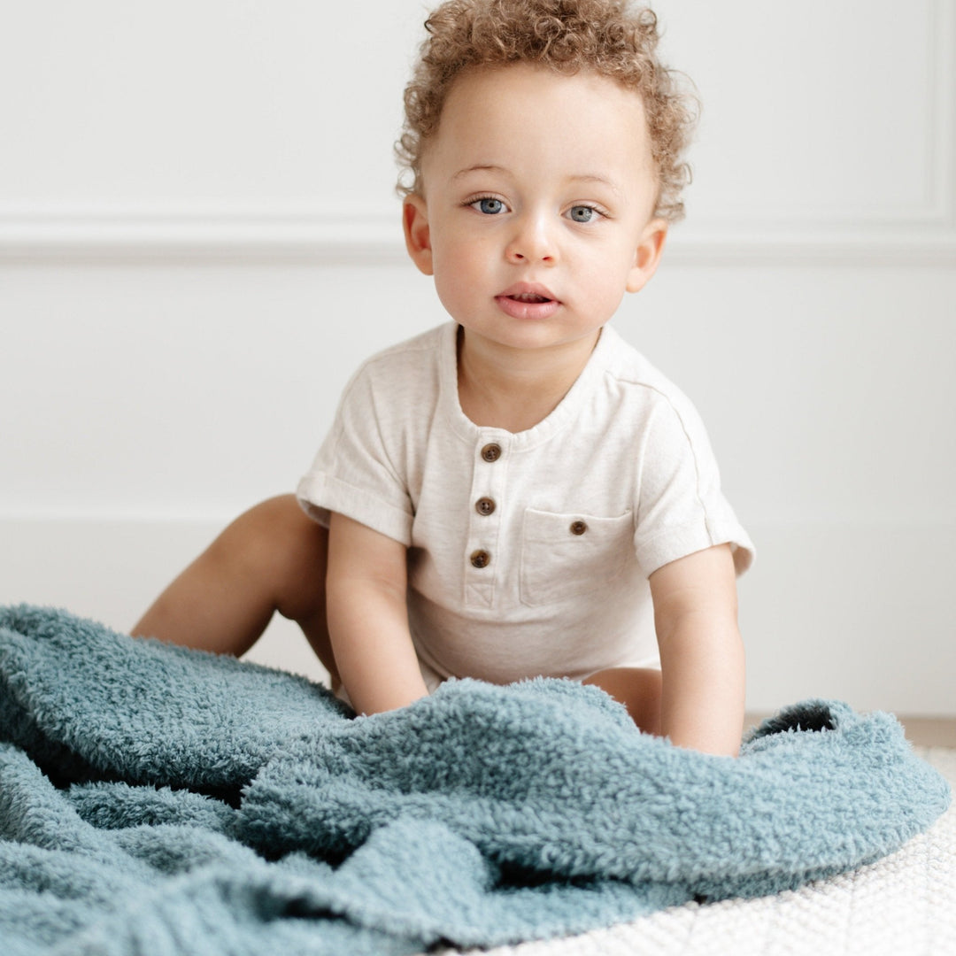 The Saranoni Bamboni¨ Receiving Blanket in Spruce brings soothing softness, ideal for a newborn receiving blanket.
