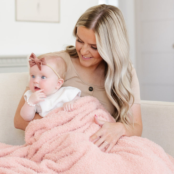 Snuggle your infant in style with the Saranoni Bamboni¨ Receiving Blanket in Peach, designed for baby boy blankets.