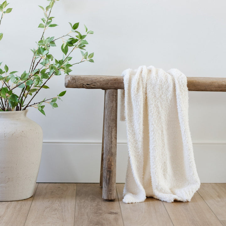 The Ivory BAMBONI¨ Toddler Blanket from Saranoni delivers plush comfort as one of the best toddler blankets.