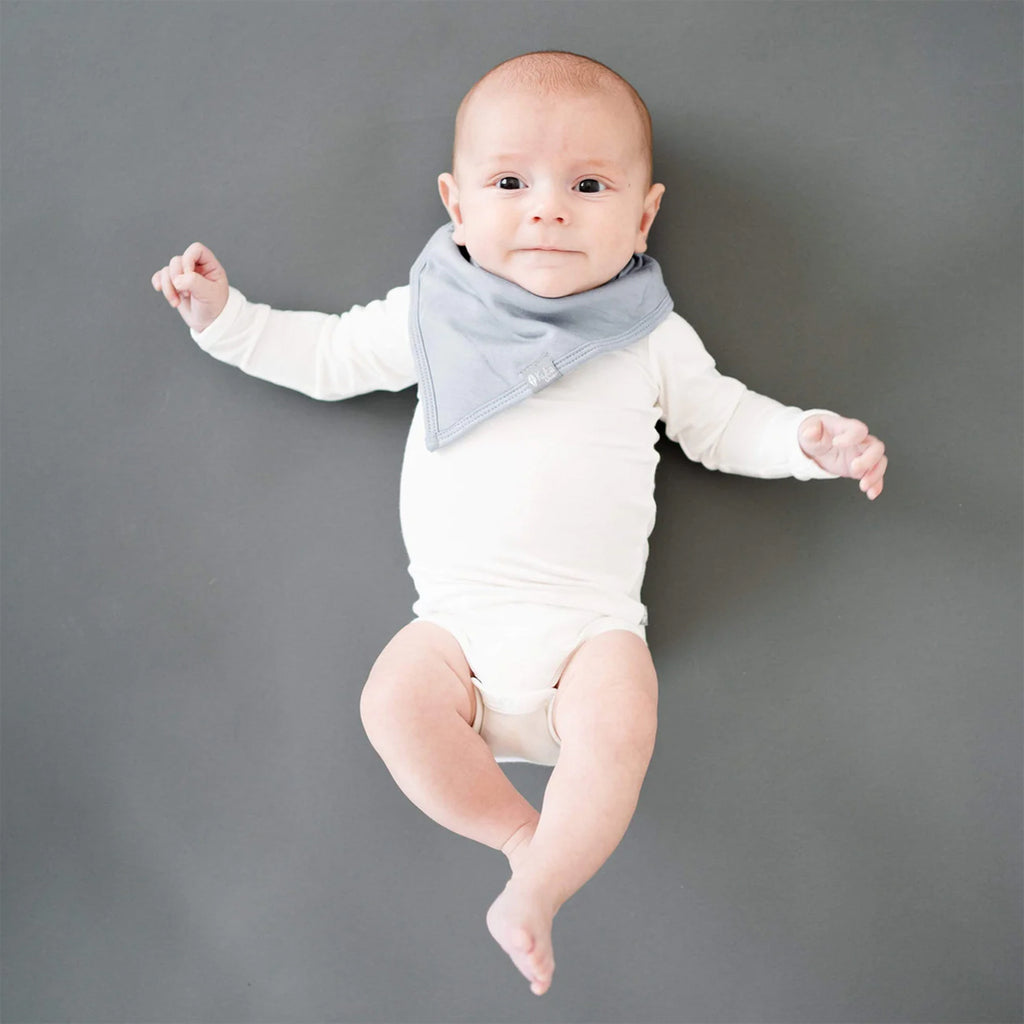 infant wearing Kyte best baby bibs in grey