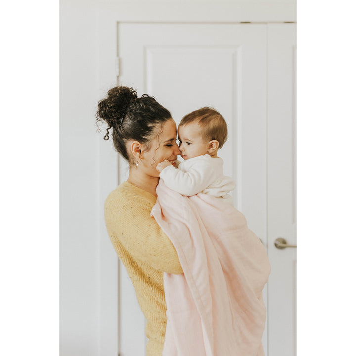 The Little Unicorn Deluxe Muslin Quilt - Blush brings classic comfort to baby girl blankets.