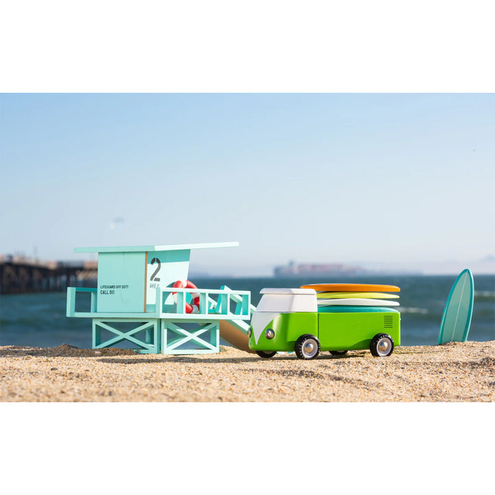 A playful wooden bus by Candylab, ideal for kids' beach adventures.