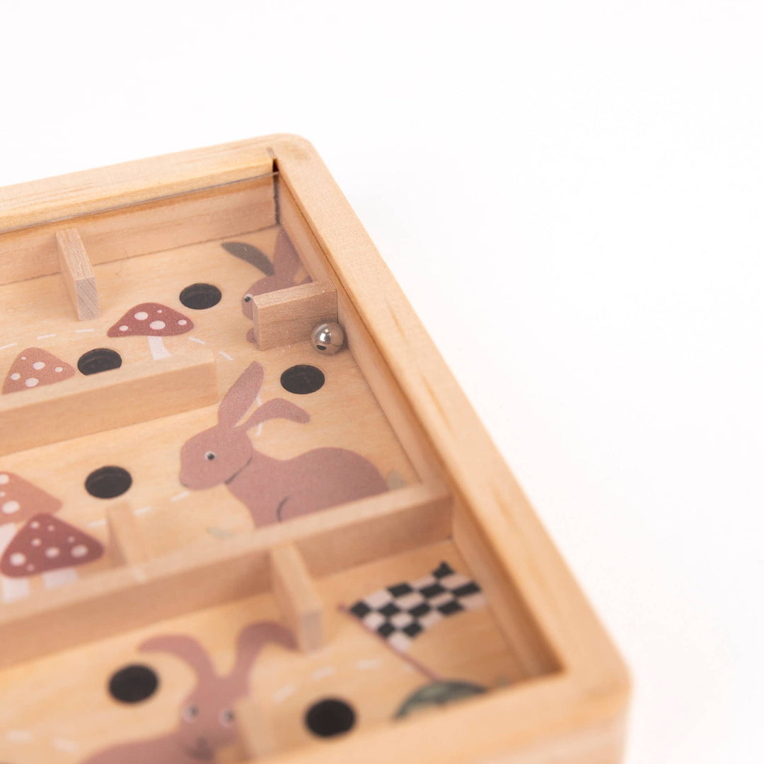 Close up, the rabbit and mushroom design on Egmont's Mini Wooden Labyrinth comes into focus