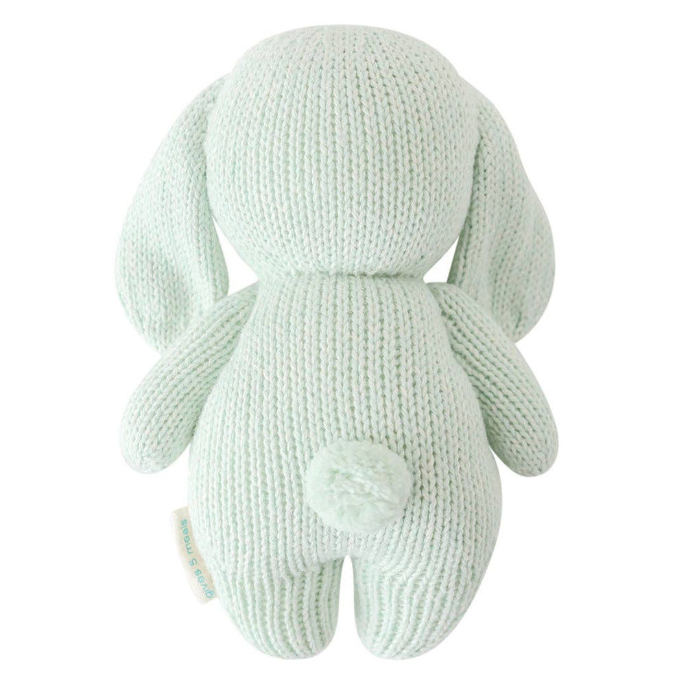 back side of baby bunny in mint by cuddle and kind hand knit stuffed toy
