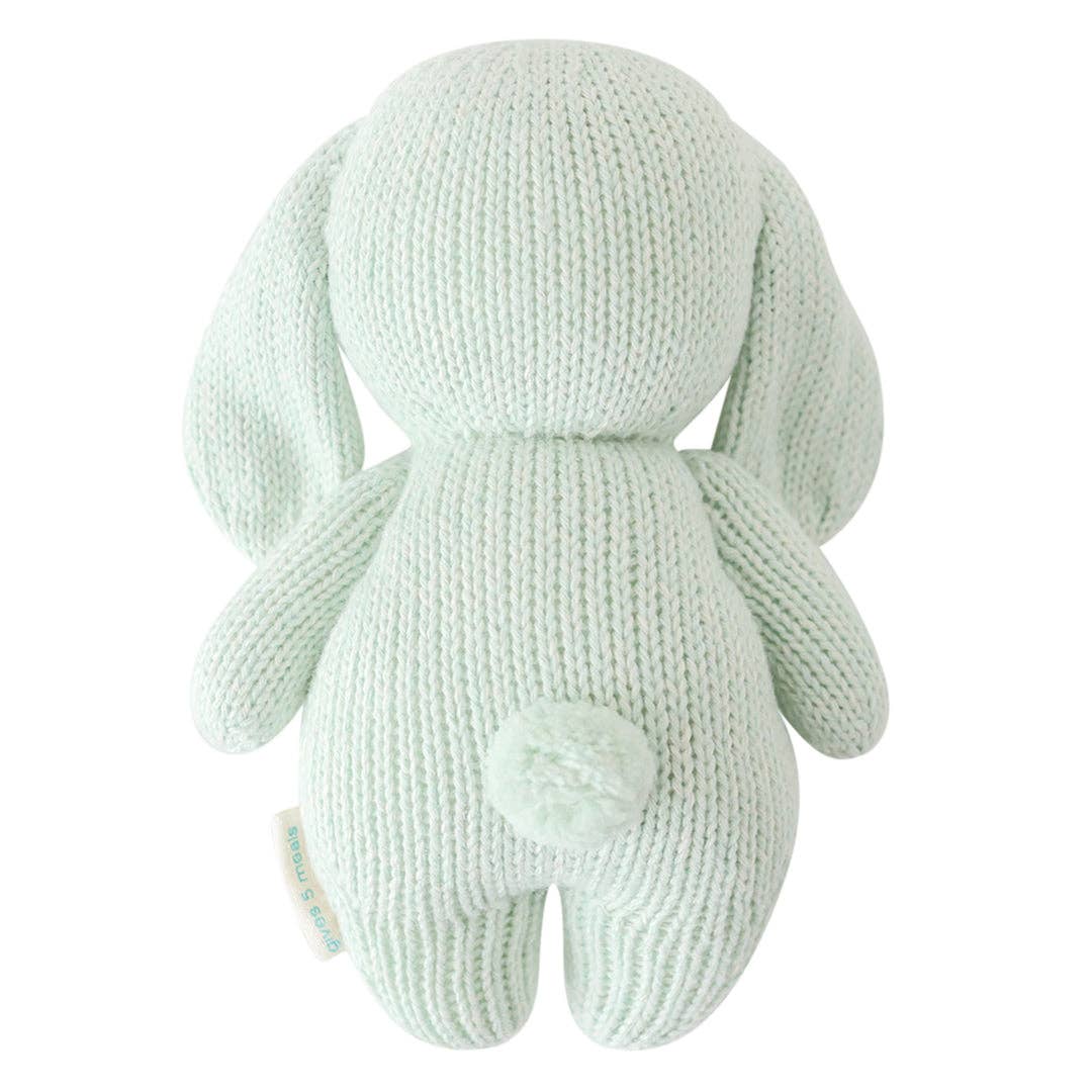back side of baby bunny in mint by cuddle and kind hand knit stuffed toy