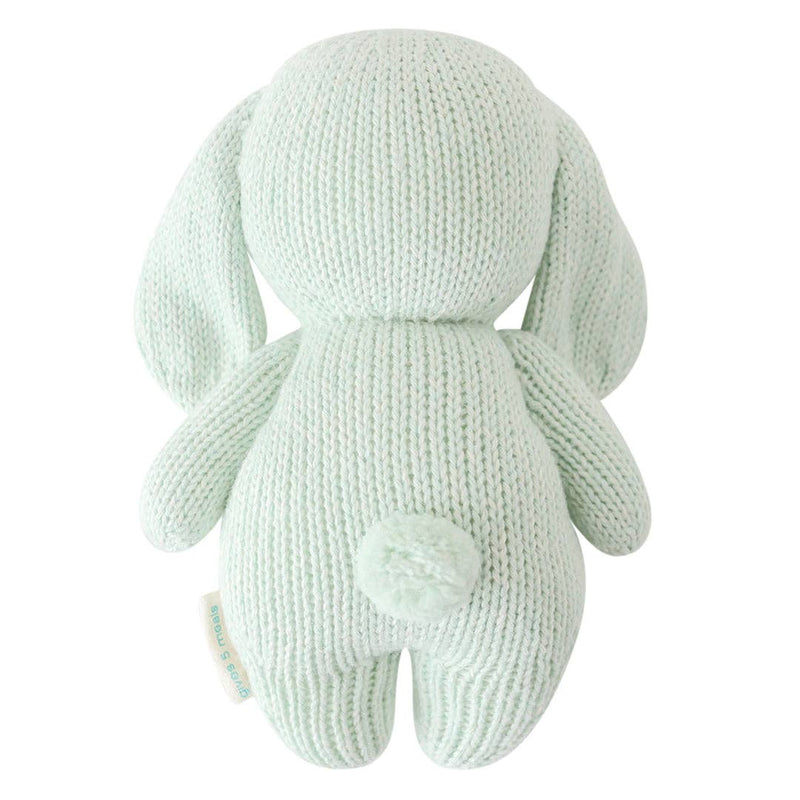 back side of baby bunny in mint by cuddle and kind hand knit stuffed toy