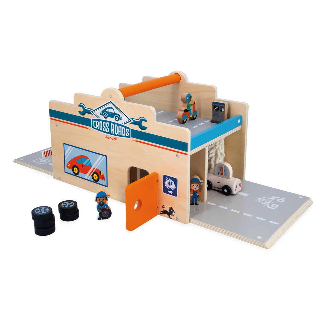 Child playing with Janod Crossroads My First Garage tow truck toy