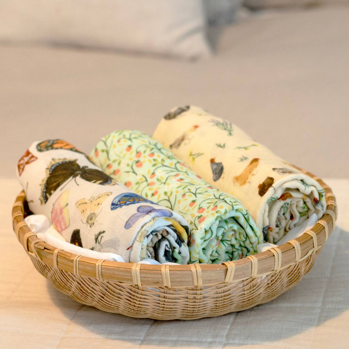 Chicken Meadows baby swaddle by 1canoe2 rolled in a basket with coordinating muslin swaddle blanket patterns