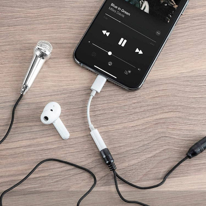 Mini Karaoke Microphone children's karaoke toy plugged into iPhone with headphones visible