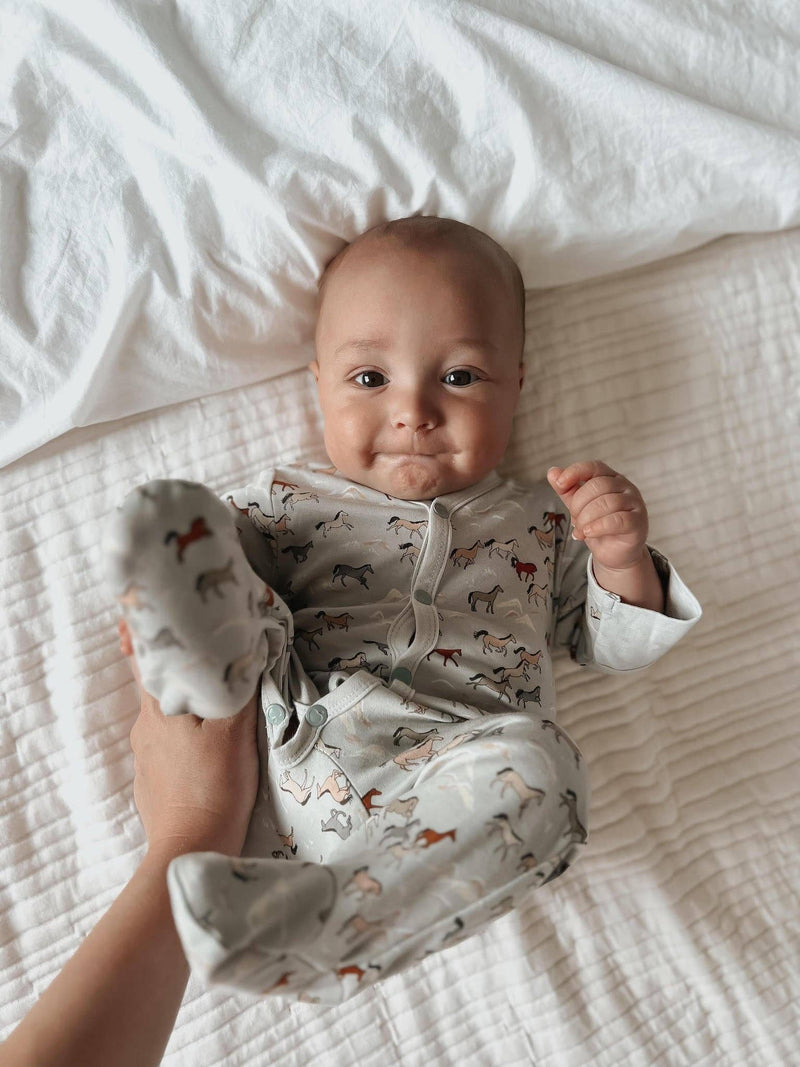 baby wearing apple park wild horse onesie 