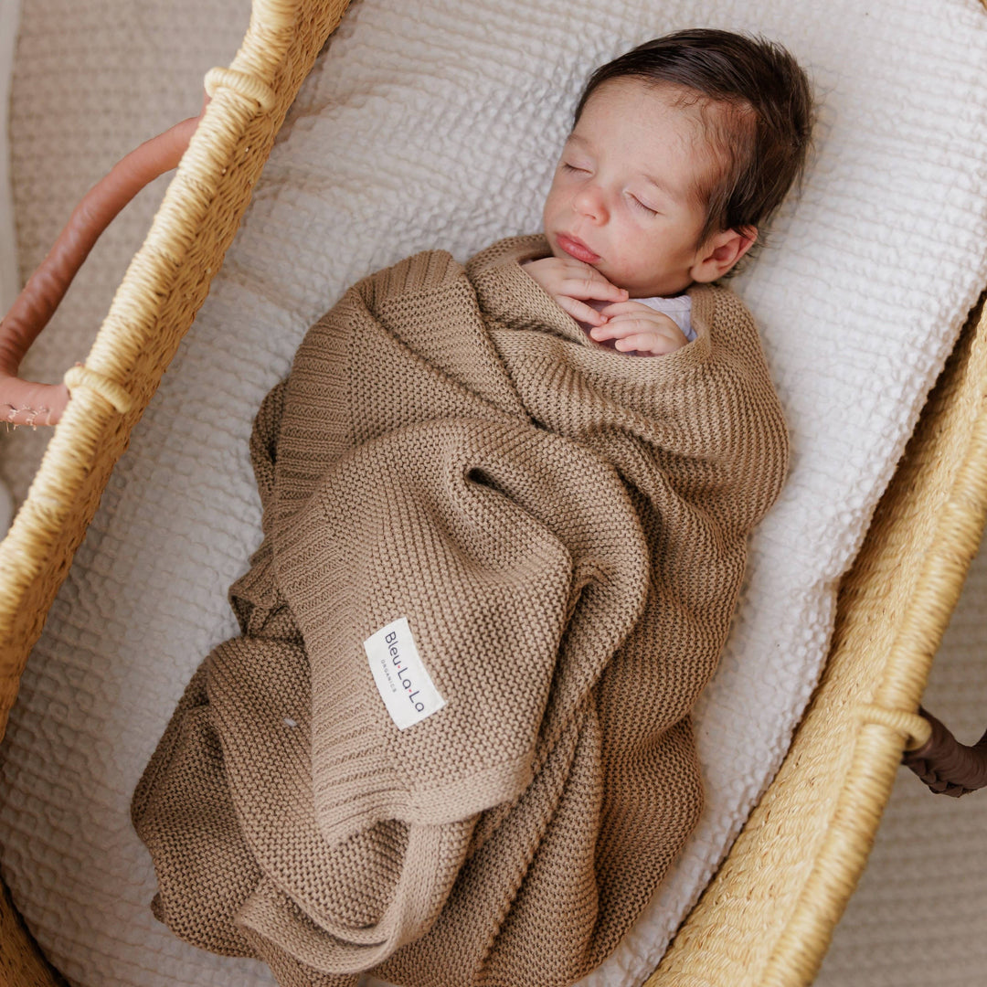 Baby sleeping swaddled in the 100% Organic Cotton Bleu La La Heritage Knitted Swaddle in Sugar Plum 
