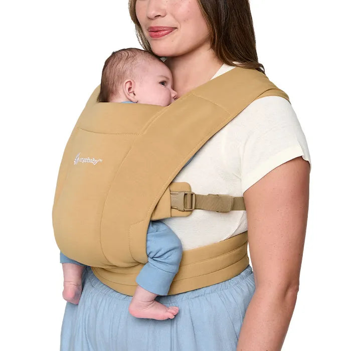Embrace gentle support with the Camel Ergobaby Embrace Newborn Carrier, a soft-structured baby chest carrier.
