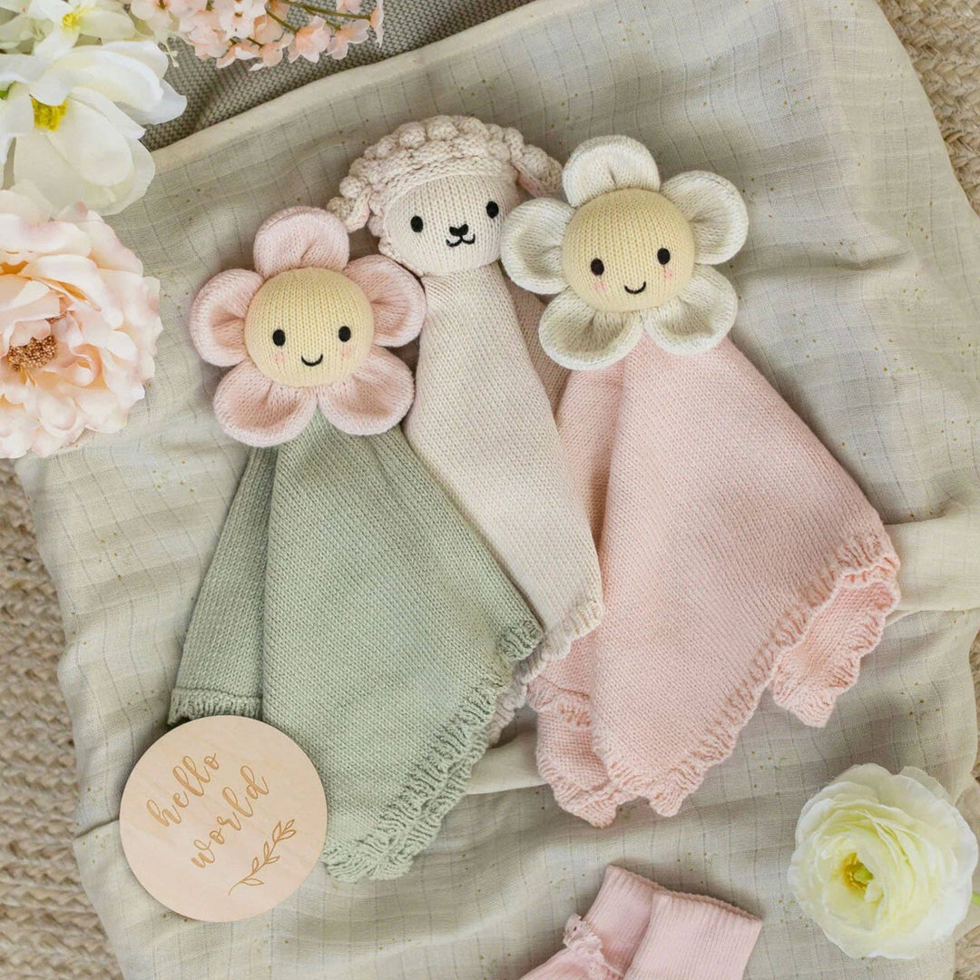 Cuddle + Kind daisy lovey Blush lifestyle — soft pink lovey blanket soothes babies during sleep