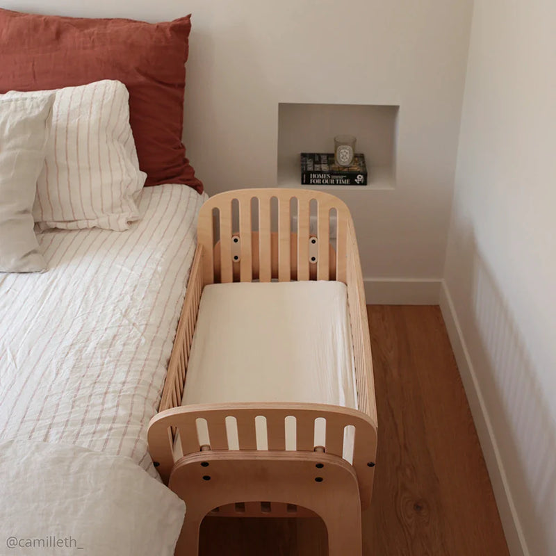 charlie crane kodo co sleep crib next to bed showcasing safe newborn sleep set up 