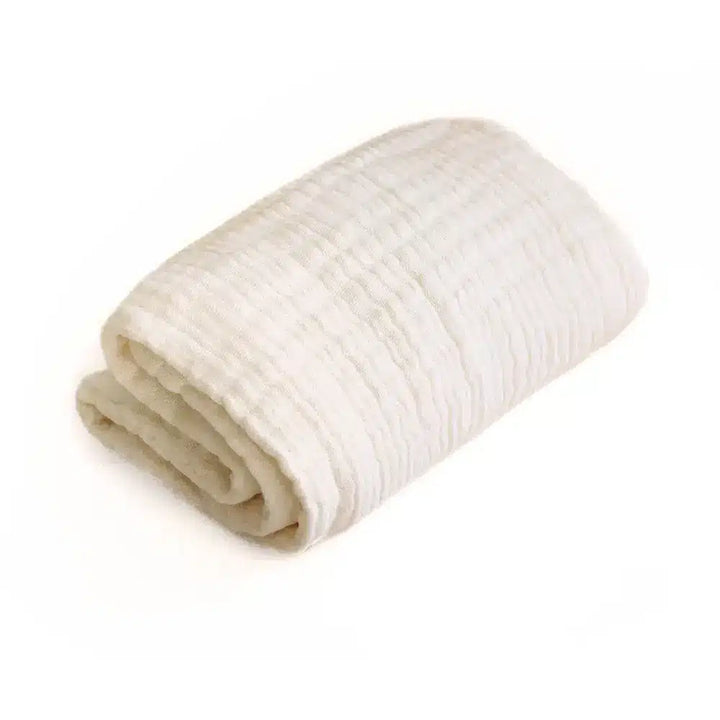 Gently styled Charlie Crane Doli Milk Blanket in milk color made from organic cotton for a cozy and breathable baby essential