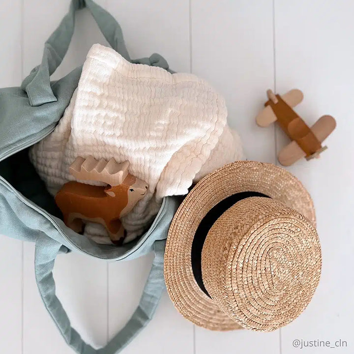 Classic nursery essential shows the Charlie Crane Doli Milk Blanket in milk designed as a comfortable baby swaddle