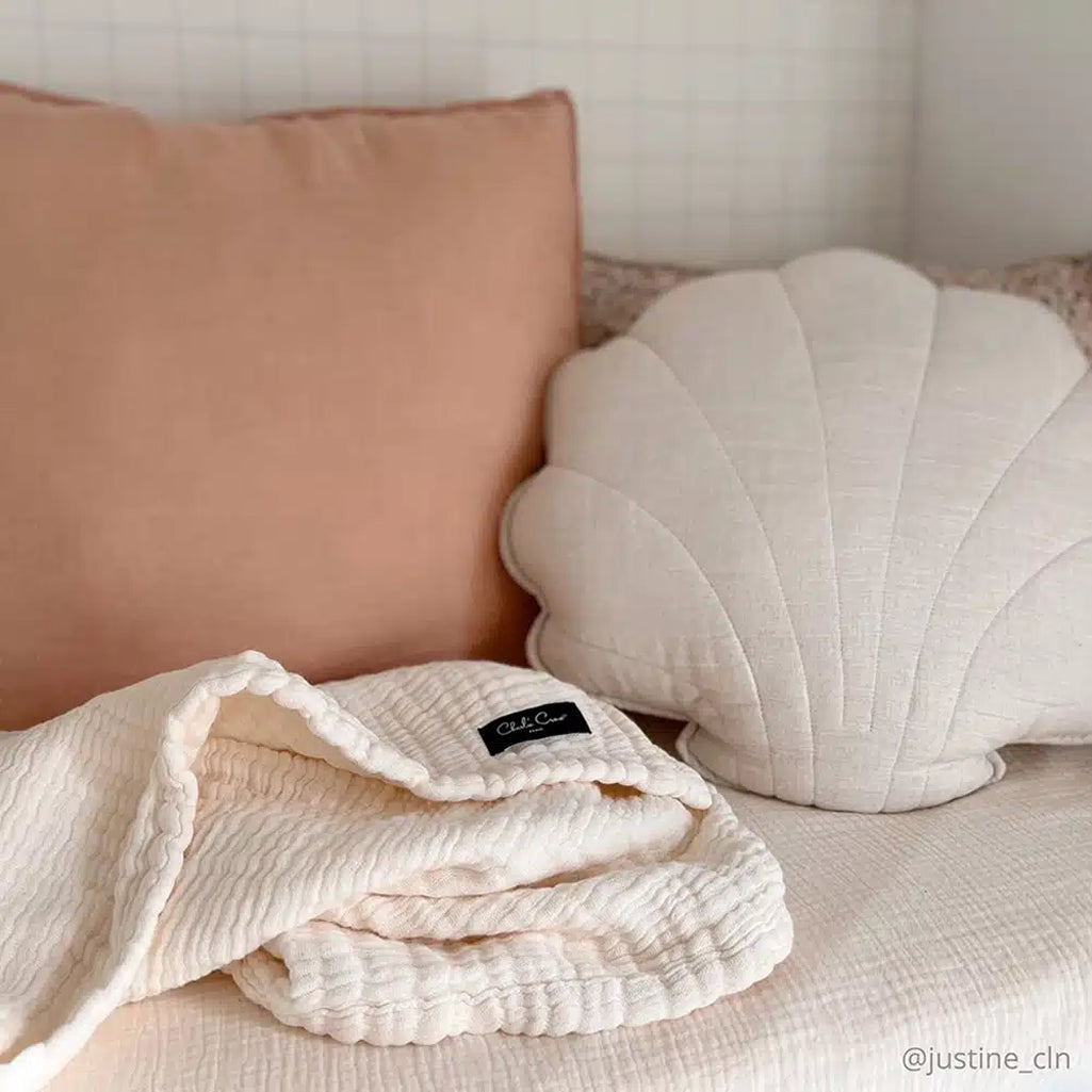 Neutral toned Charlie Crane Doli Milk Blanket in milk displayed as a versatile receiving blanket for daily use