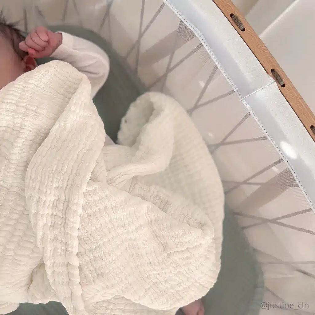 Close detail of the Charlie Crane Doli Milk Blanket in milk featuring a knit design perfect for a newborn blanket