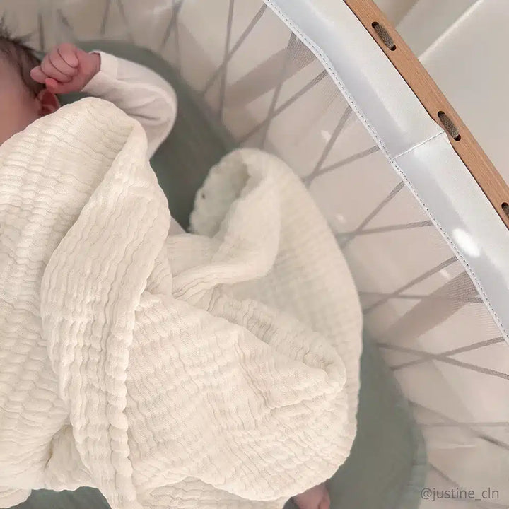 Close detail of the Charlie Crane Doli Milk Blanket in milk featuring a knit design perfect for a newborn blanket