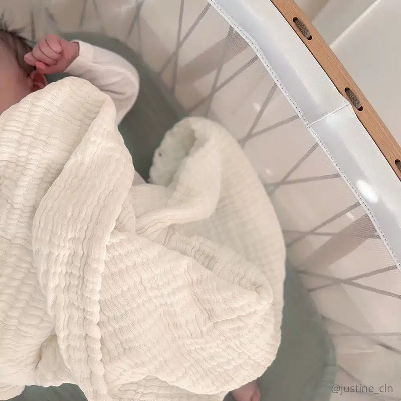 Close detail of the Charlie Crane Doli Milk Blanket in milk featuring a knit design perfect for a newborn blanket