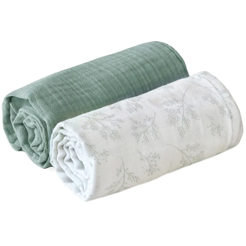 Flat lay presentation shows the Charlie Crane DOLI Swaddle Set in milk camel and lichen with a soft feel for gentle use