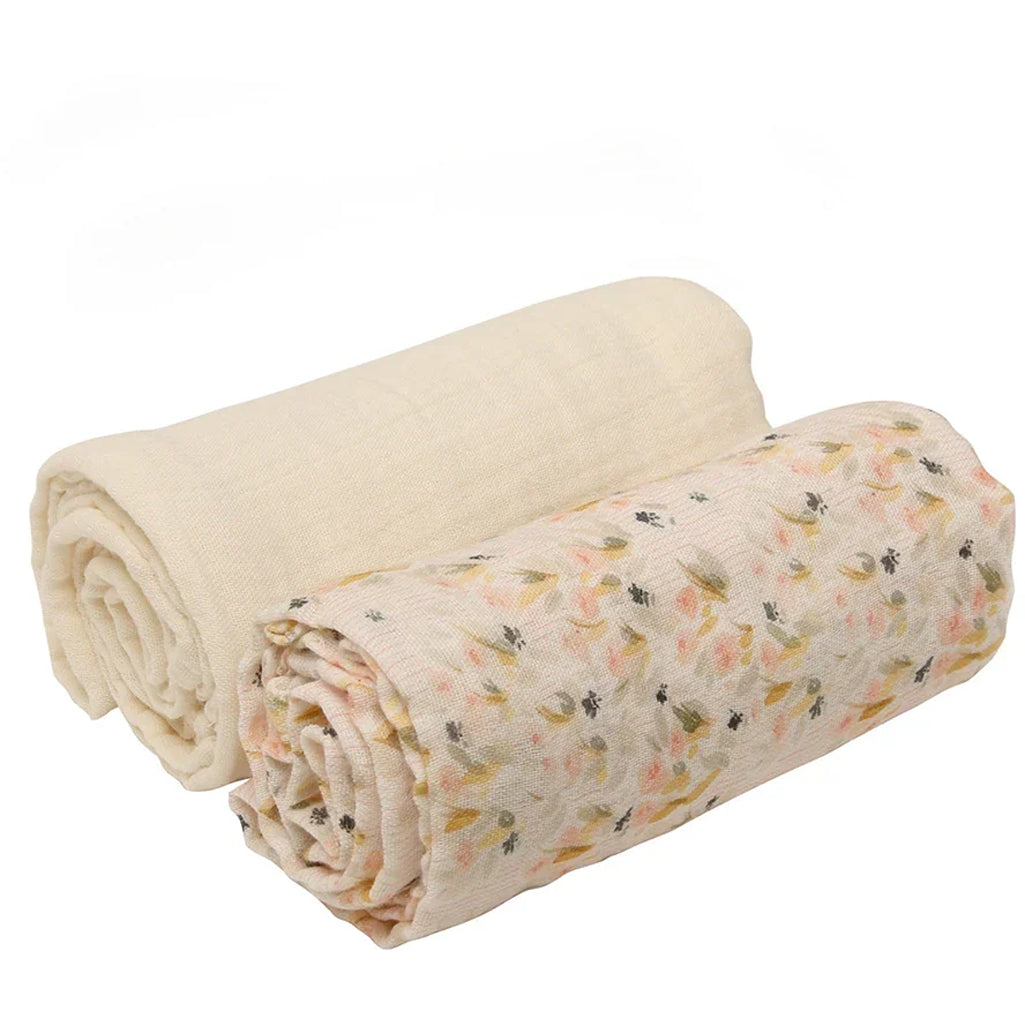 Styled nursery view of the Charlie Crane DOLI Swaddle Set in milk camel and lichen made from organic cotton for everyday baby comfort