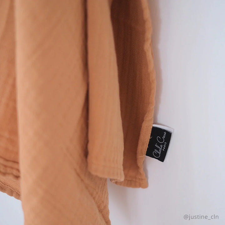 Soft color palette emphasizes the Charlie Crane DOLI Swaddle Set in milk camel and lichen suited for blanket receiving moments