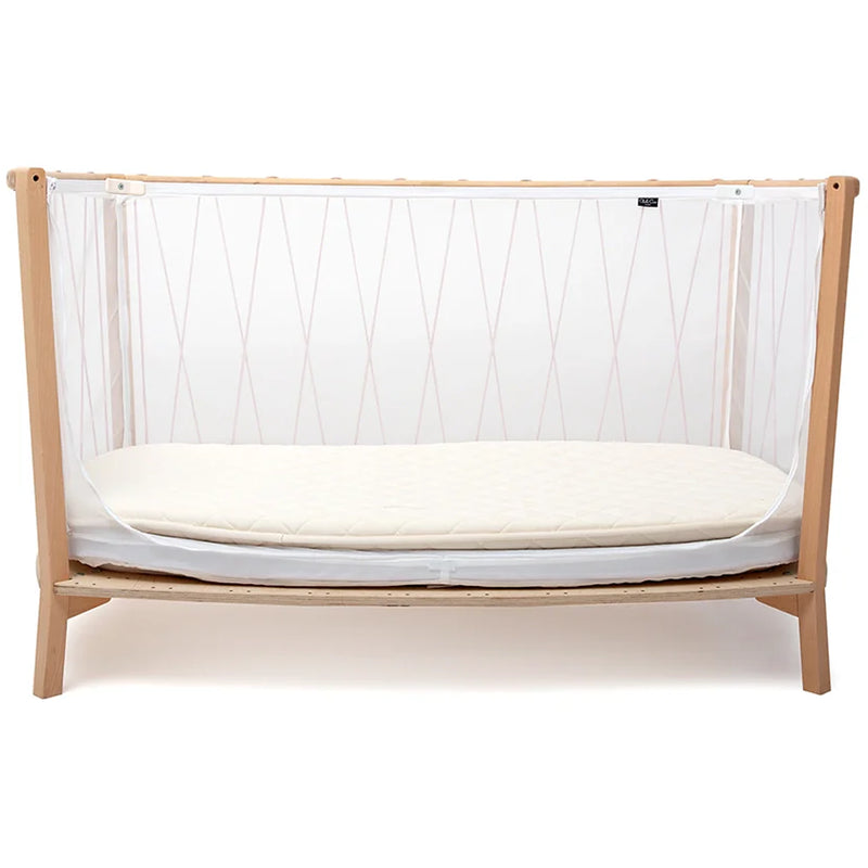 Sophisticated nursery setup presents the Charlie Crane KIMI Evolving Baby Bed in hazelnut as a child bed with organic construction