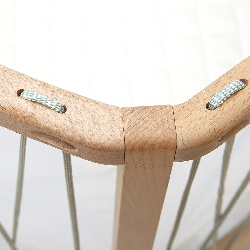 Soft nursery light displays the Baby Bed KIMI Evolving Charlie Crane in bois de rose with organic and infant safe design