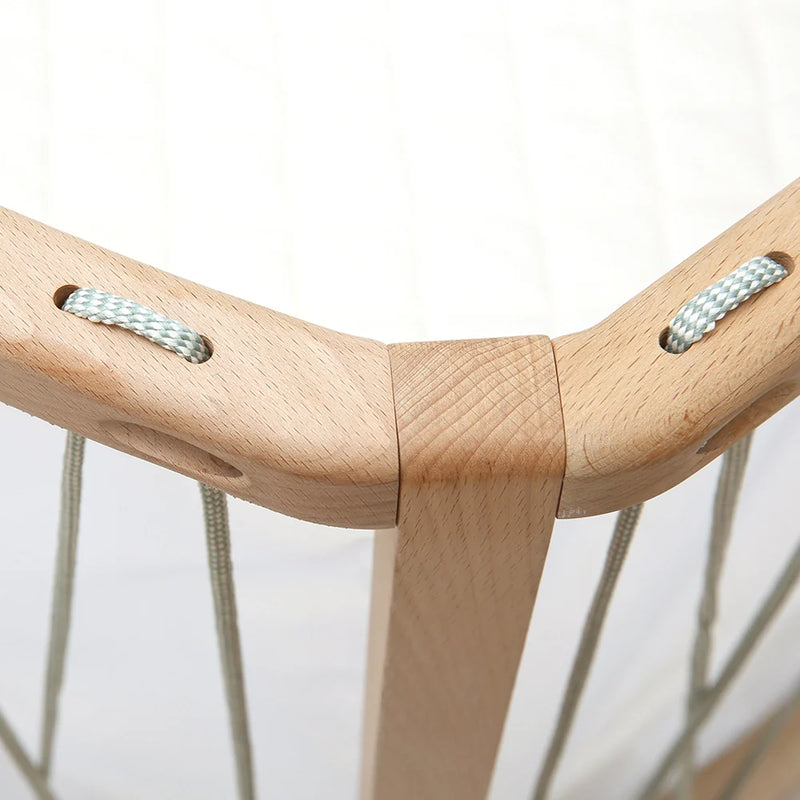 Soft nursery light displays the Baby Bed KIMI Evolving Charlie Crane in bois de rose with organic and infant safe design