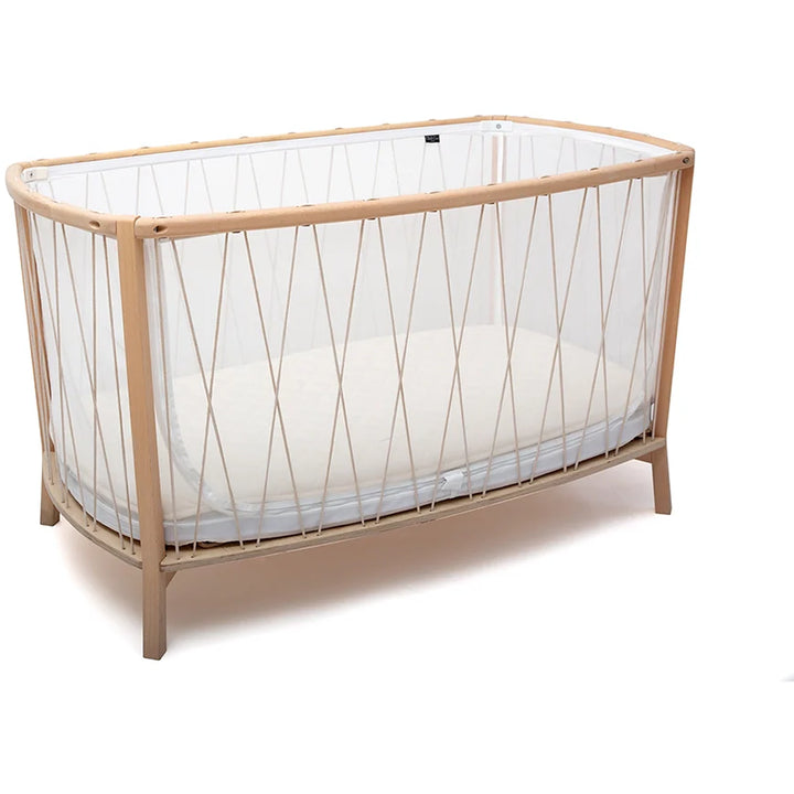 Hazelnut crib corner features the Charlie Crane Baby KIMI Evolving Bed designed to grow with child safely