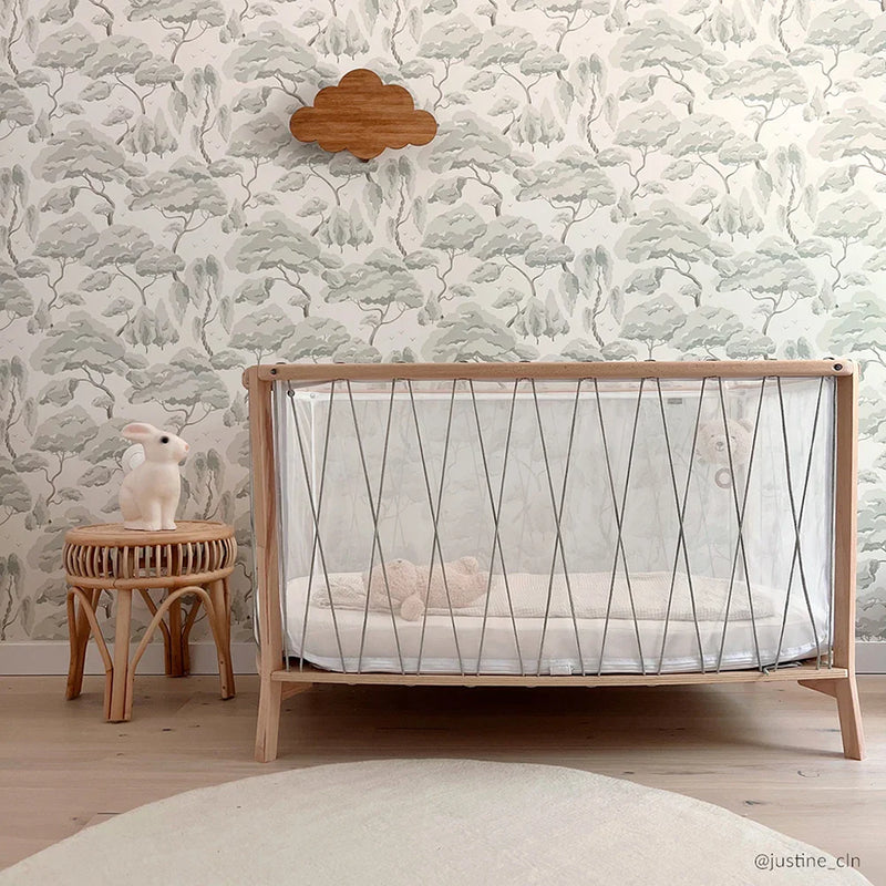 Desert nursery accent displays the KIMI Baby Evolving Bed Charlie Crane with handcrafted European beech