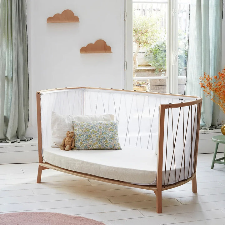 Desert child-ready vignette presents the Baby KIMI Evolving Bed Charlie Crane with handcrafted European beech and organic finish