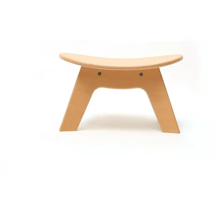 Soft textured seating presents the Charlie Crane Wooden HIBO Stool in natural with a minimalist finish