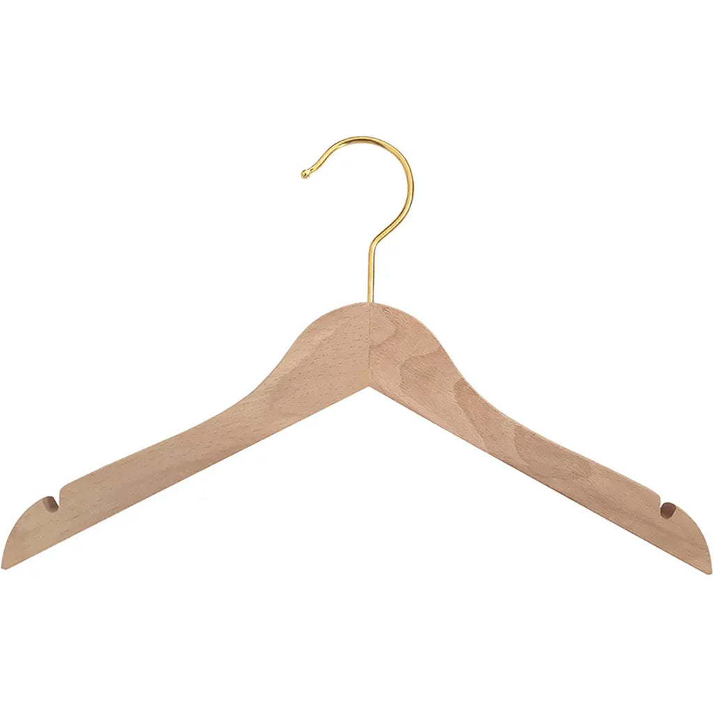 Soft lighting highlights the Charlie Crane Wooden HOMI Hangers in natural with a minimalist nursery decor style