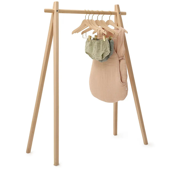 Angled room view presents the Charlie Crane HOMI Rack in natural with a midcentury modern silhouette for stylish storage