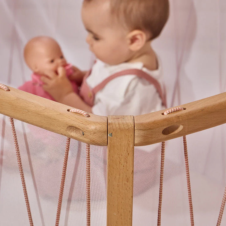 Organic nursery decor showcases the Charlie Crane KIMI Evolving Baby Bed in hazelnut with a safe, European beech frame