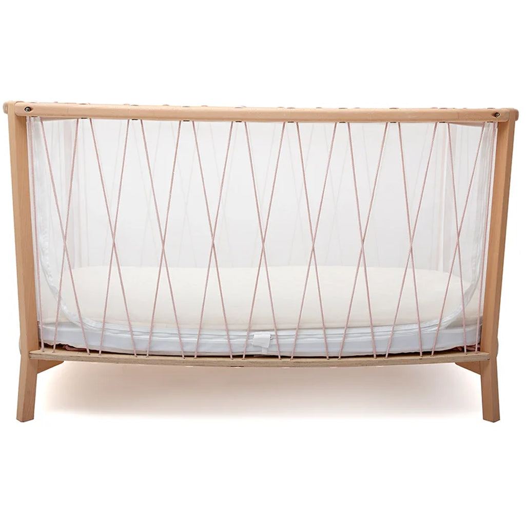 Cozy corner vignette highlights the KIMI Evolving Bed Charlie Crane in desert designed to grow with child from newborn crib