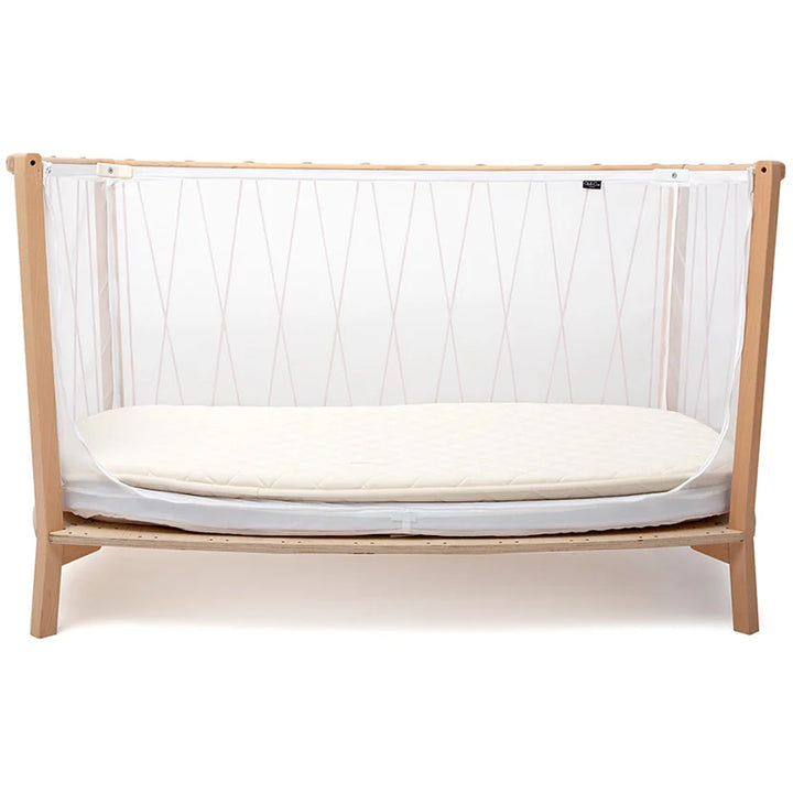Child-ready setup displays the Charlie Crane Baby Bed KIMI Evolving in bois de rose crafted for infant safe use
