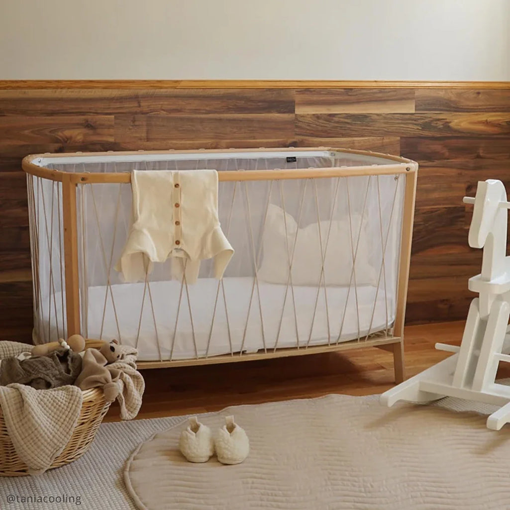 Softly styled interior presents the KIMI Evolving Baby Bed Charlie Crane in lichen with a French-inspired nursery decor touch
