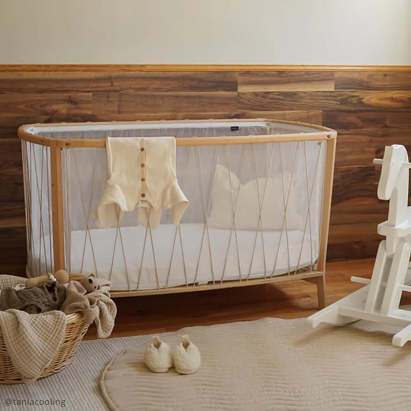 Softly styled interior presents the KIMI Evolving Baby Bed Charlie Crane in lichen with a French-inspired nursery decor touch