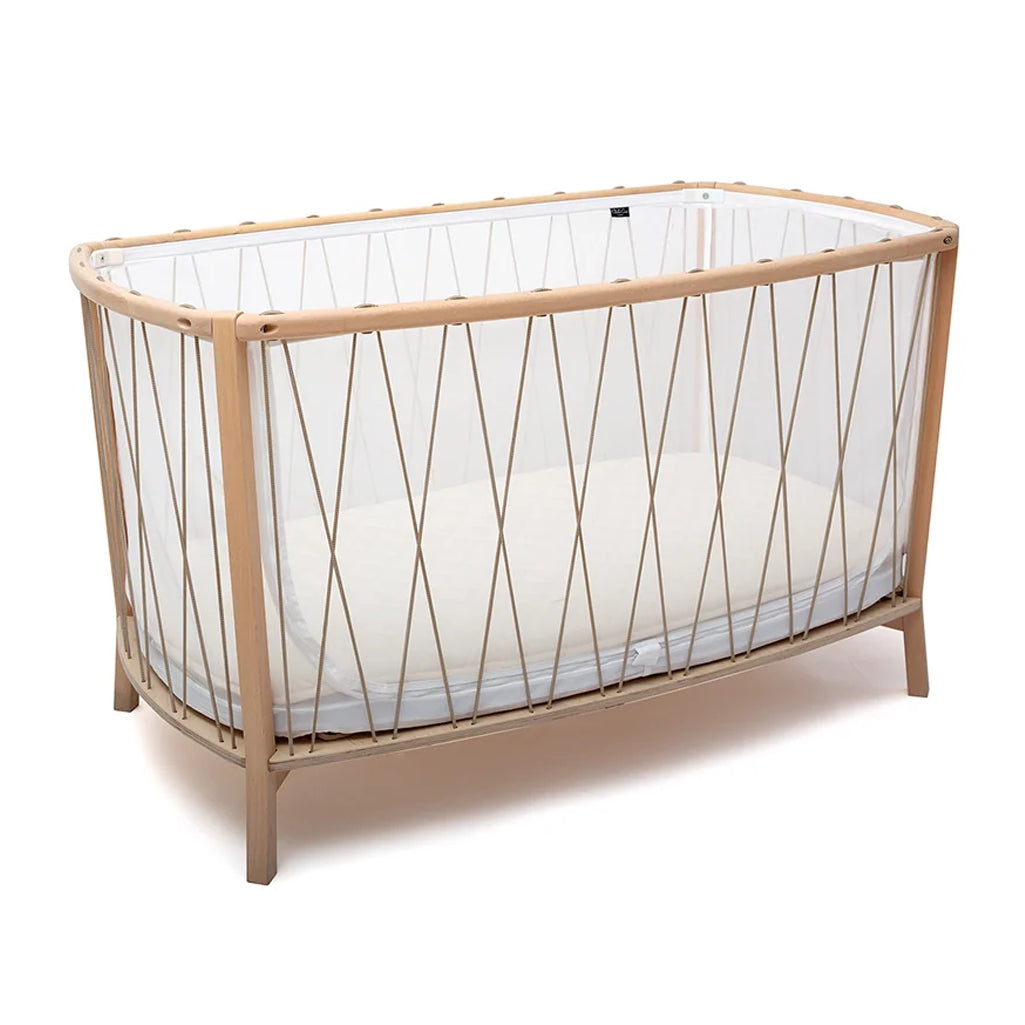 Classic nursery vignette highlights the Charlie Crane KIMI Evolving Bed in hazelnut as a toddler bed and junior bed solution