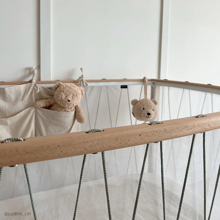 Neutral palette styling displays the KIMI Bed Evolving by Charlie Crane in bois de rose crafted for infant comfort