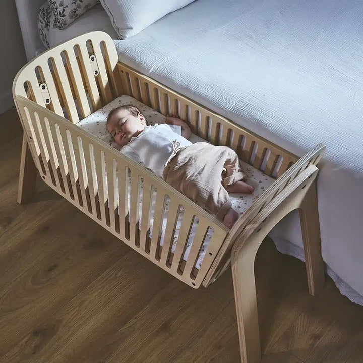 Peaceful infant area presents the KIMI Cord Charlie Crane in natural with sustainable design