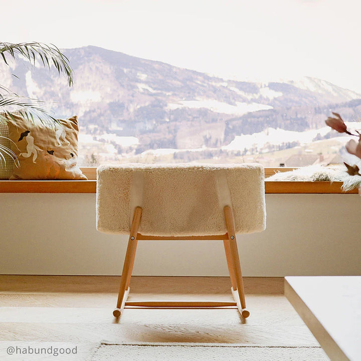 Timeless nursery styling features the Charlie Crane KUKO Bassinet in milk fur as a gentle rocking bassinet