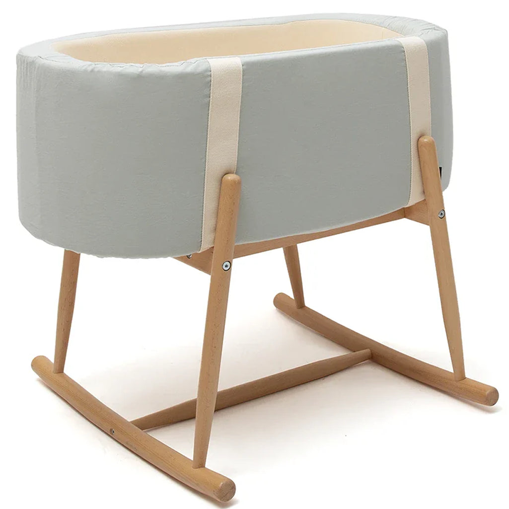 Warm interior view features the KUKO Bassinet Charlie Crane in farrow with a wooden design