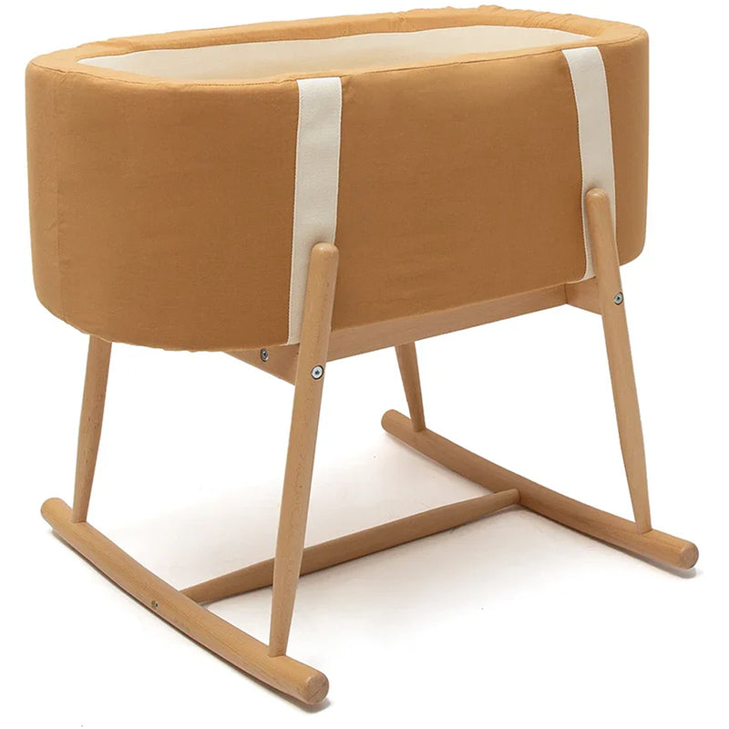 Soft nursery setting shows the Charlie Crane KUKO Bassinet in milk fur with a midcentury modern look