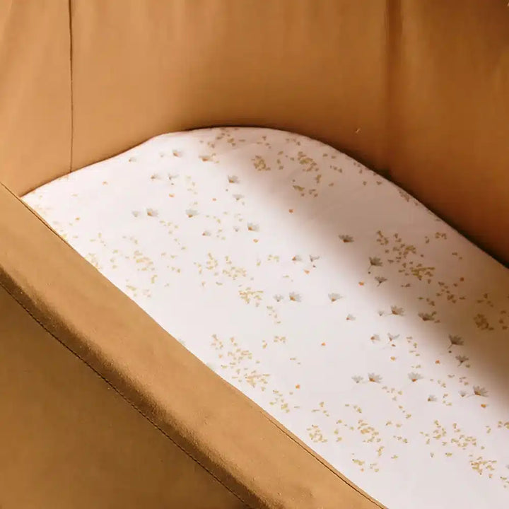 Timeless nursery bedding presents the Charlie Crane KUMI and KUKO Fitted Sheet in milk with gentle softness