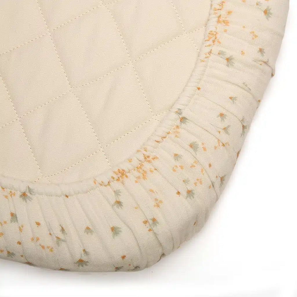 Eco minded nursery scene shows the Charlie Crane Fitted Sheet KUMI and KUKO in milk as eco friendly bedding